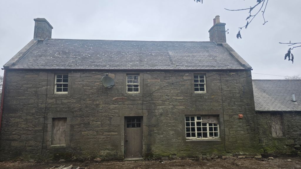 A slate roof replacement on a farmhouse building